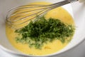 Beaten egg yolks in a bowl with whisk